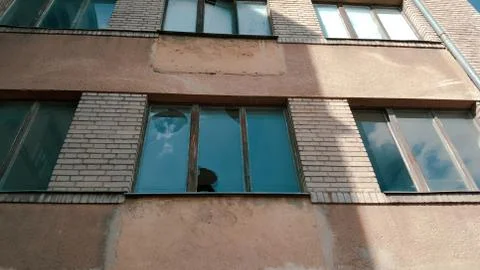 Old broken windows on an abandoned old building. Stock Photos