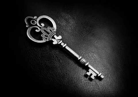 Old bronze key on a dark background Stock Photos