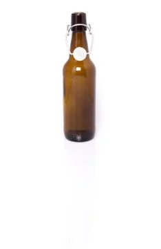 Old brown bottle of beer isolated on white. Stock Photos