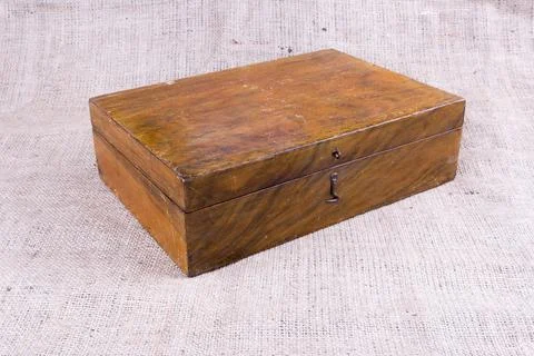 Old brown box on burlap Stock Photos