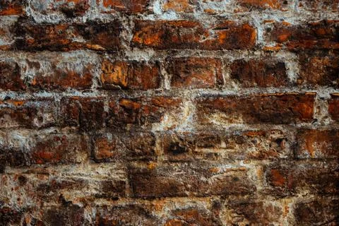 Old brown brick wall covered with salt in an old European city Stock Photos