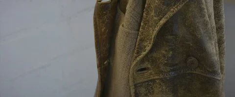 Old brown leather jacket inside a workshop Stock Footage 127417834