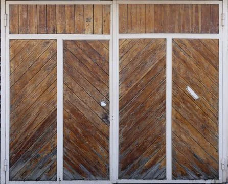 Old brown massive rustic doors with oblique wood layout Stock Photos