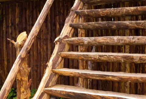 Old brown orange rustic construction. Plank log stairs stairway ladder in front Stock Photos