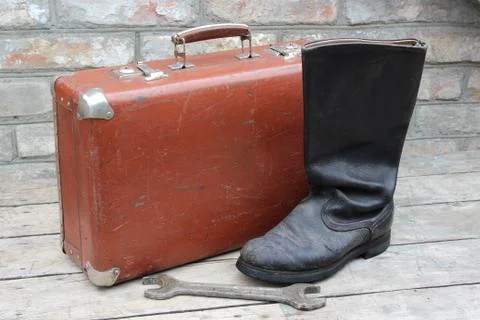 Old brown suitcase with boot Stock Photos