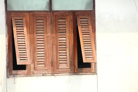 Old brown window opening and closed. Stock Photos