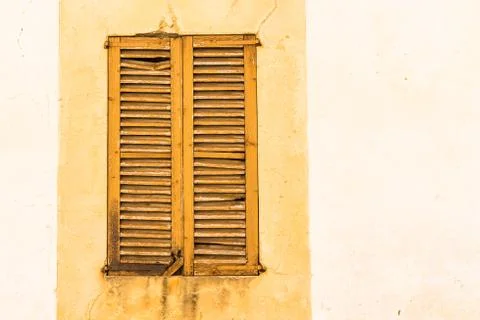 Old brown window shutter of mediterranean house Stock Photos