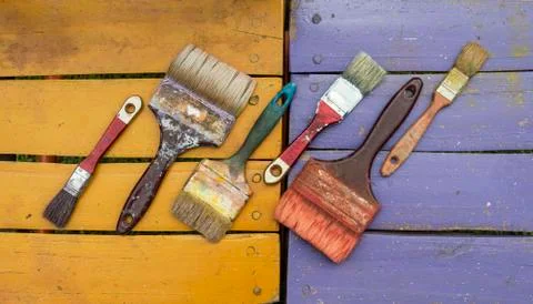 Old brushes on colors Stock Photos