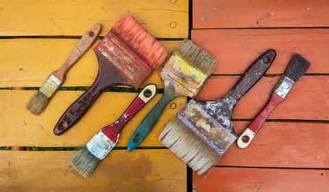 Old brushes on colors Stock Photos