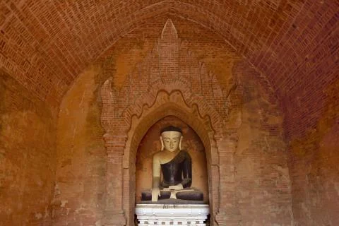Old Buddha statue inside buddhist temple in Bagan, Myanmar. Stock Photos