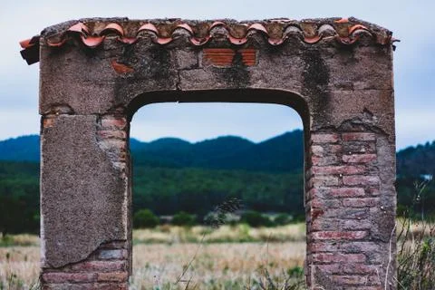 Old building arc with mountain in the background Stock Photos