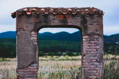Old building arc with mountain in the background Stock Photos