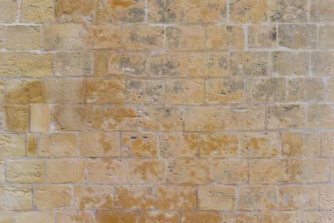 Old building bricks wall made of limestone Stock Photos