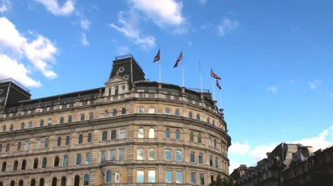 Old building with British flags waving in the wind near Trafalgar Square Stock Footage 51668227