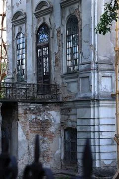 Old building with broken windows and damaged walls in a city undergoing Stock Photos