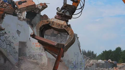 Old building demolition. Heavy machine removing construction debris Stock Footage 98617036