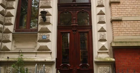 Old building with elegant door in germany during fall season pan out view Stock Footage 230488244