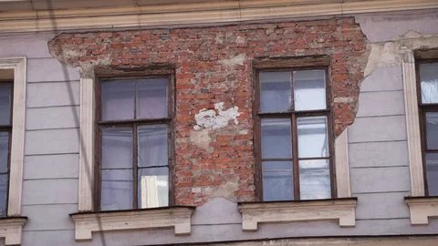 Old building facade with brick wall and couple of windows in daylight. Stock Footage 107111228