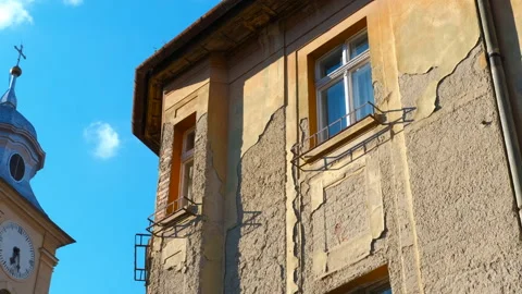 Old building facade gradually revealing clock tower under blue sky Stock Footage 314995768