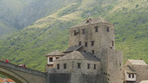 The old building of the famous Mostar bridge with tourists, in Bosnia Stock Footage 241655765