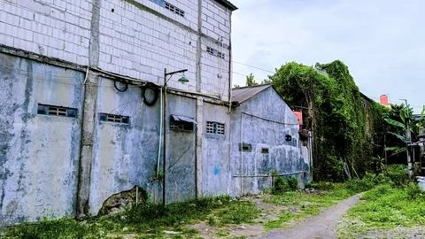 An old building with a grey wall Stock Photos