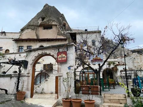 An old building inside a cliff with an arch. Caption: Ascension Cave Costumes Stock Photos