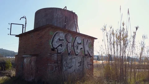 Old building in the middle of nowhere with graffiti Stock Footage 125929645