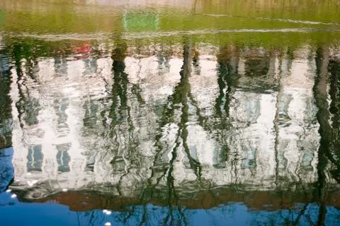 Old building reflection in river waters Stock Photos