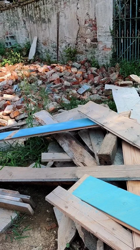 Old Building Ruins with Piled Bricks and Discarded Wooden Planks In a Derelict Stock Footage 313860022