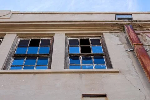 Old building  with rusty drain pipe, missing windows in Globe, Arizona. Stock Photos