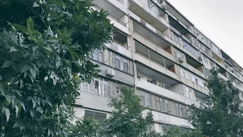Old building in soviet or east european style, gray sky shooting from bottom to Stock Footage 243316597