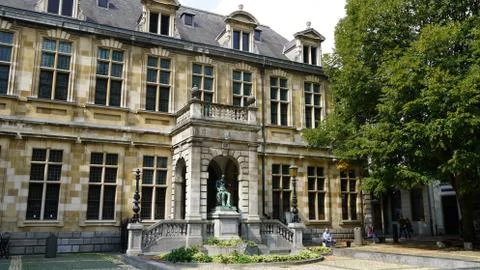 Old building with statue in Antwerp. Stock Photos
