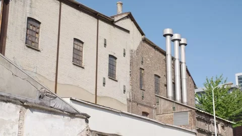 Old building on sunny day next to newer building Stock Footage 240180038