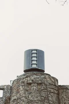 Old building with a tall structure on top standing against the clear sky in.. Stock Photos