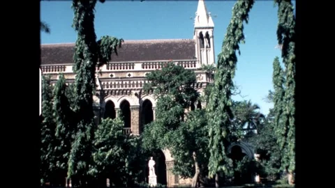Old building with tall trees in front of it Stock Footage 274092169