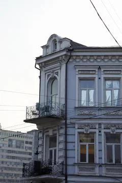Old building with unique architectural design in a busy city area during Stock Photos