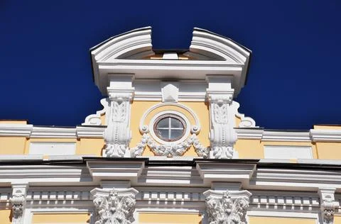 Old building. View of the attic window of a yellow building. Stock Photos
