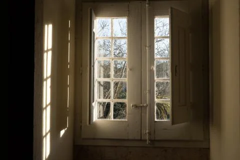 Old building window facing the gardens Stock Photos