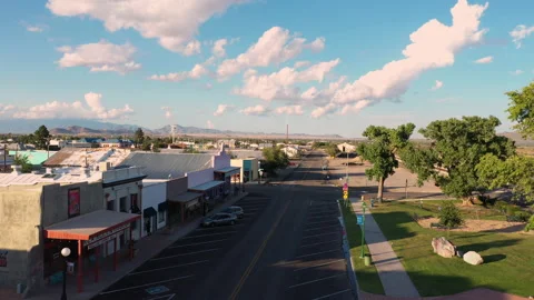 Old buildings and empty parking spaces in Willcox, Arizona, aerial forward Stock Footage 166074694