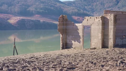 Old buildings emerging from empty swamp due textreme dryness in Spain. Stock Footage 265306413