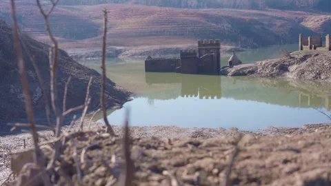 Old buildings emerging from empty swamp due textreme dryness in Spain. Stock Footage 265306434