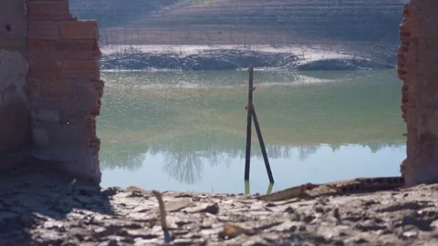 Old buildings emerging from empty swamp due textreme dryness in Spain. Stock Footage 265306570