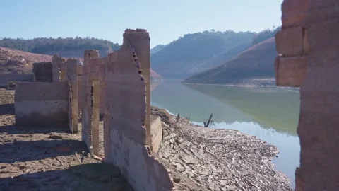Old buildings emerging from empty swamp due textreme dryness in Spain. Stock Footage 265306592