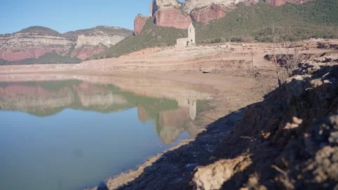 Old buildings emerging from empty swamp due textreme dryness in Spain. Stock Footage 265307012