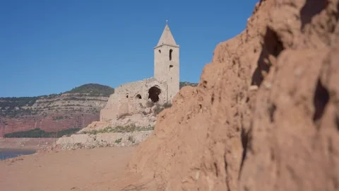 Old buildings emerging from empty swamp due textreme dryness in Spain. Stock Footage 265307021