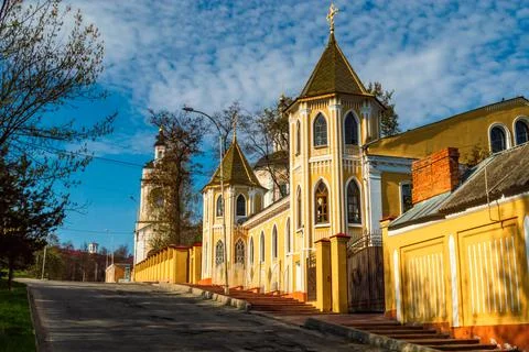 Old buildings in the Gothic style in the rays of the setting sun against the Stock Photos
