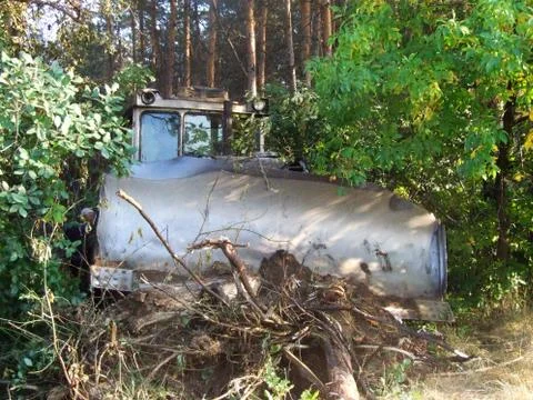 Old bulldozer clears a path in the woods Stock Photos