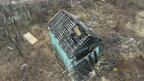 Old burnt of fire burned-down wooden house after fire, natural catastrophe Stock Footage 206399126