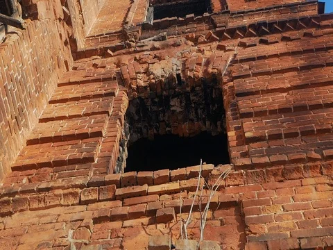The old burnt-out abandoned red-brick building without windows and doors. pan Stockbeeldmateriaal 84852966