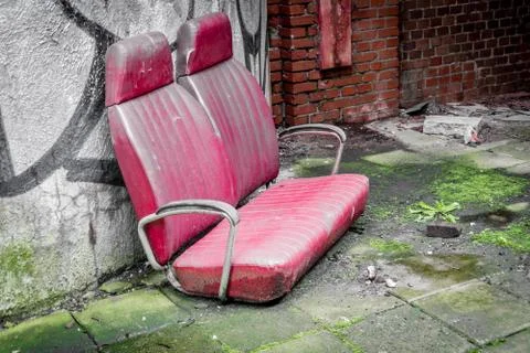 Old bus bench left behind, destroyed in a old ruin building Stock Photos